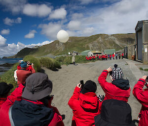 Tourists taking photos of the weather balloon release