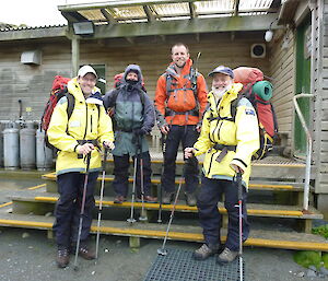 4 expeditioners standing on the verandah with their packs on