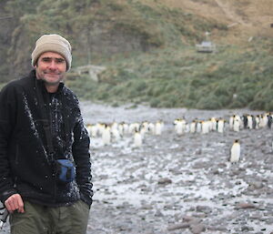 Expeditioner on the beach, slight snow fall