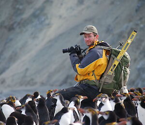 Expeditioner taking photos of penguins