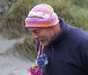 Expeditioner wearing a multi coloured out of shape beanie as a joke