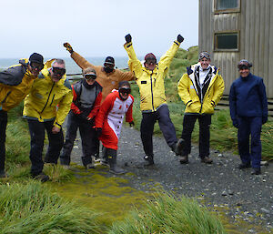 Eight expeditioners standing alonside of each other wearing goggles