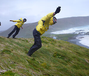 Two expeditioners leaning into the wind