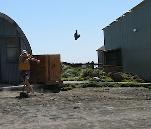 Expeditioner throwing a boot into the air