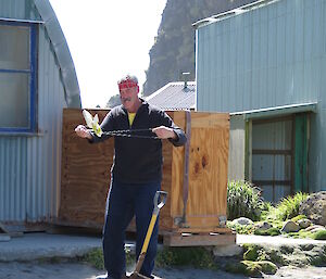 Expeditioner getting ready to throw a phone, old building in background