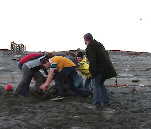 Expeditioners in two teams tackling each other to get to the ball