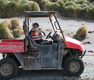 Expeditioner behind the wheel of the towed small ute hiding his face with a cloth