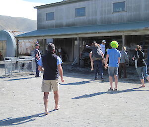 Expeditioners playing soccer run to the corner as they score a goal