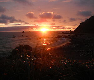 Bright red orange sunset over the coast