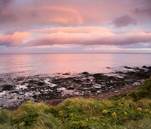 Mix of red and orange sunset colours over the ocean