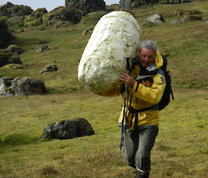 Expeditioner carrying a large white buoy