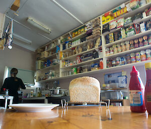 Inside the hut a bottle of tomato sauce and a loaf of bread on the table