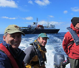 Three expeditioners in an inflatable boat