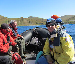 Four expeditioners in an inflatable boat heading towards land