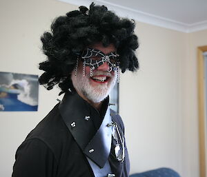 Male expeditioner wearing a black wig and studs in his lip looks like a punk rocker