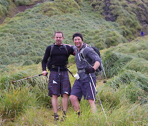 Two runners leaning against each other after running 34km