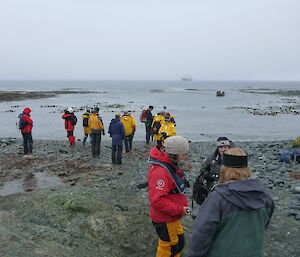 Many people on the beach as people arrive to tour the station by foot