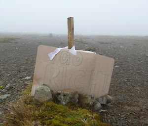 A cardboard sign saying go Richard on the track