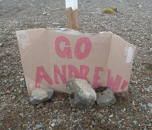 Cardboard sign on the track saying go Andrew