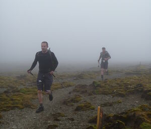 Both runners single file running in mist