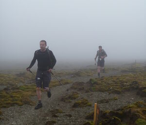 Both runners single file running in mist