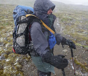 Female expeditioner dressed in wet weather gear on the plateau