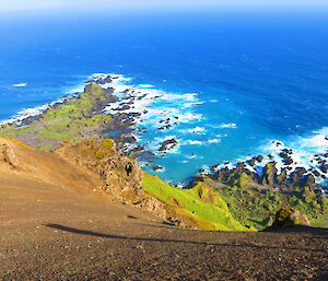 Very steep scree slope ocean in background