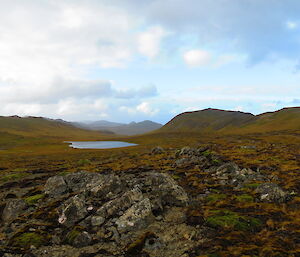 Rolling hills high on the plateau with lake in background