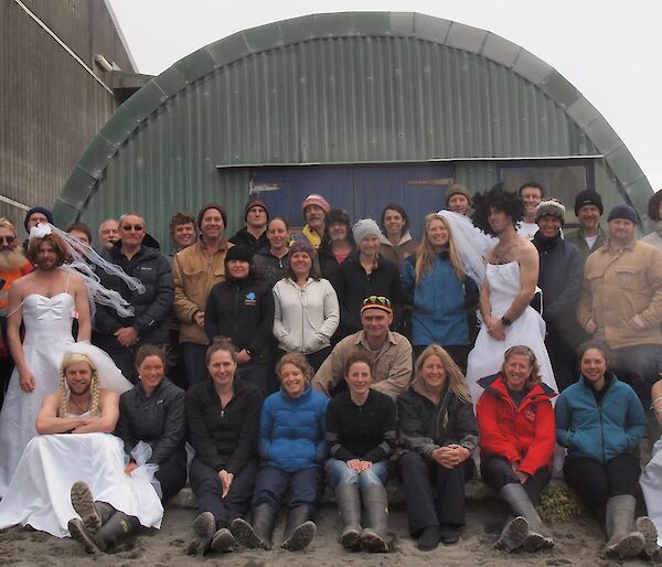 36 expeditioners, four males wearing wedding dresses