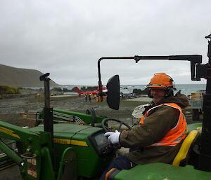 Male expeditioner driving a tractor