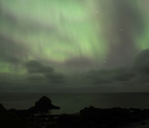 Aurora australis or southern lights, appearing like a greenish silk curtain, as seen from the Ham hut looking southeast over Buckles Bay