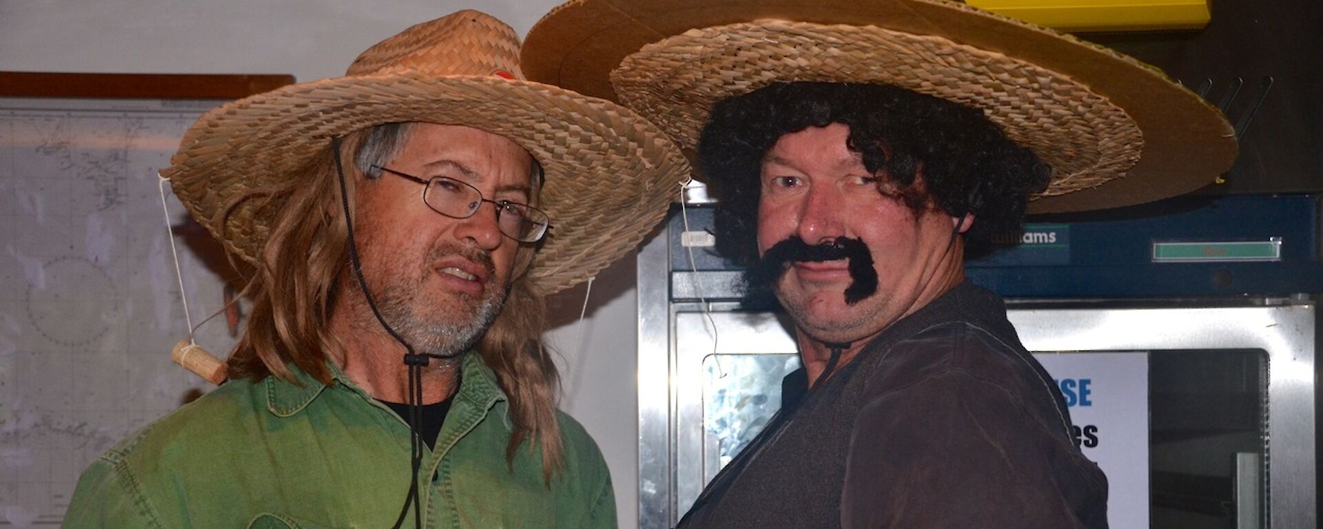 Two men dressed in Mexican theme outfits, Clive with a wide brimmed hat and a long hair wig, while Dave is wearing a broad moustache, sombrero and a curly black wig