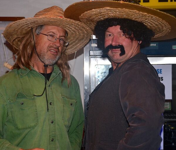 Two men dressed in Mexican theme outfits, Clive with a wide brimmed hat and a long hair wig, while Dave is wearing a broad moustache, sombrero and a curly black wig