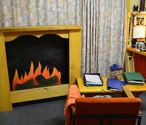 The new fake wooden fireplace installed in the chef’s room, consisting of a mockup timber fireplace, complete with a painted image of a fire