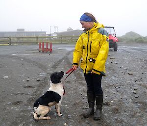 Karen standing next to a black and white springer spaniel. Ash is giving Karen his undivided attention