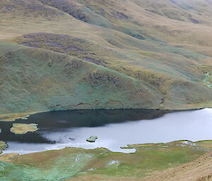 Down slope view of a small lake in a valley in the Red River area