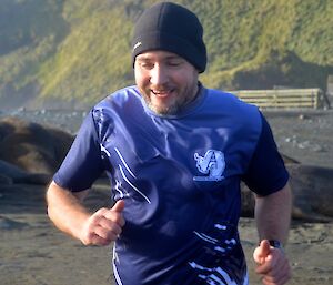 Craig gives a smile and thumbs up as he approaches the finish line