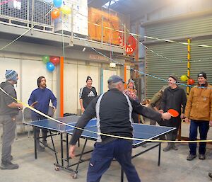Macca Team members playing table tennis with other team members watching