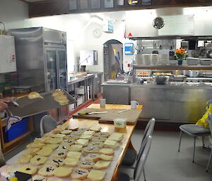 Dave in the kitchen with buns laid out making lunch for all the teams