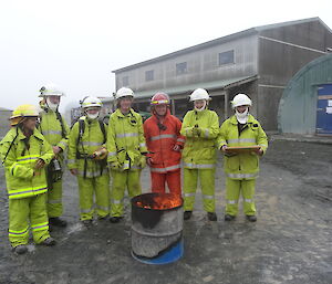 Fire team standing by fire in middle of court yard