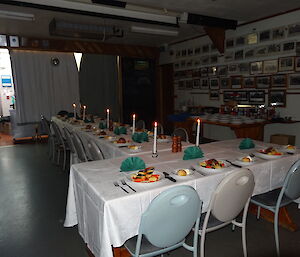 the table is set to eat with a white table cloth all cutlery is set on the tables and all meals are in their place