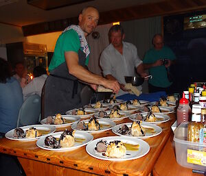 Marty and Dave getting desserts ready that are laid out on the table