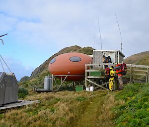 Brothers Point hut (shaped like a football) with Aaron, Tony and Marty standing near the entrance. The RAPS (Remote Area Power Supply) just on the left hand side of the hut