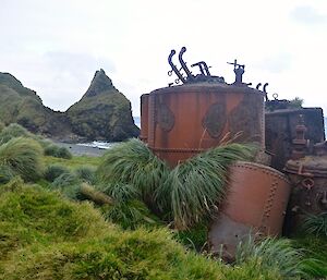 Old digesters (rusted boilers) at Nuggets Point with the Nuggets in the background