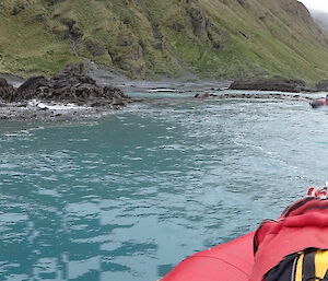 The ocean and part of Macquarie Island landscape with a boat up ahead