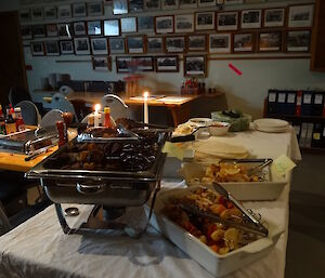 A tray lamb and chicken kebabson the table next to it are two white dishes one with fish kebabs the other with veggie kebabs some piita bread and sauces all sitting on a table with a white cloth