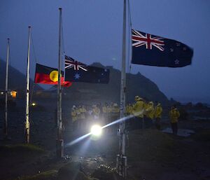 The team at the dawn service with NZ, Australian and Aboriginal flags in the foreground