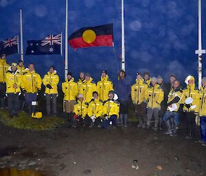 Station team in front of flags