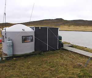 Eitel Hut, next to a small lake – a fully fitted temporary shelter, complete with an additional cold porch, with sleeping for two people and are specially designed for use by the MIPEP team whilst conducting remote operations on Macquarie Island
