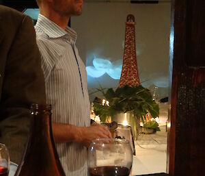 Marty standing near the table with the Eiffel Tower in the background
